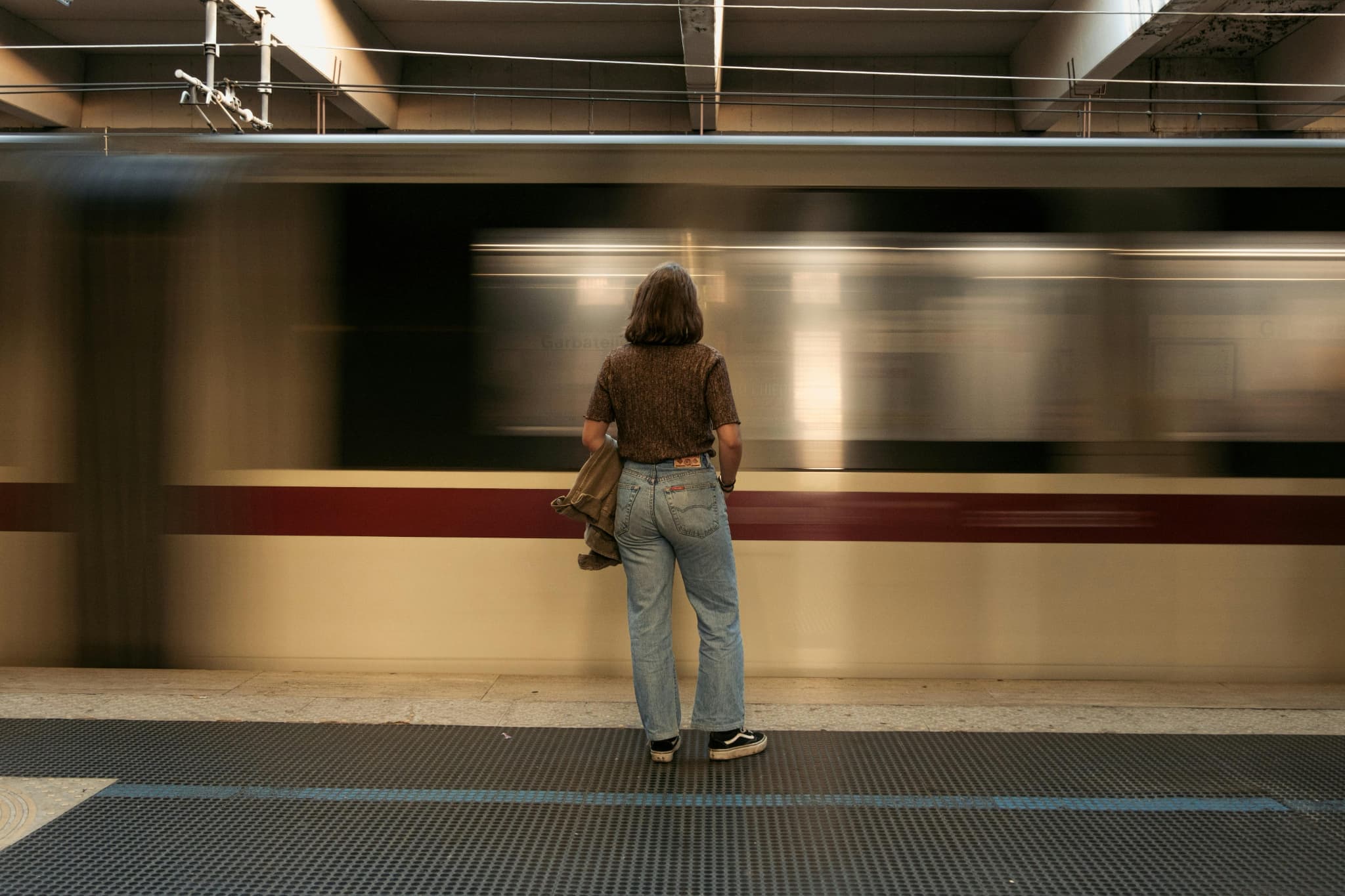 帰りの電車を見ている女性の後ろ姿